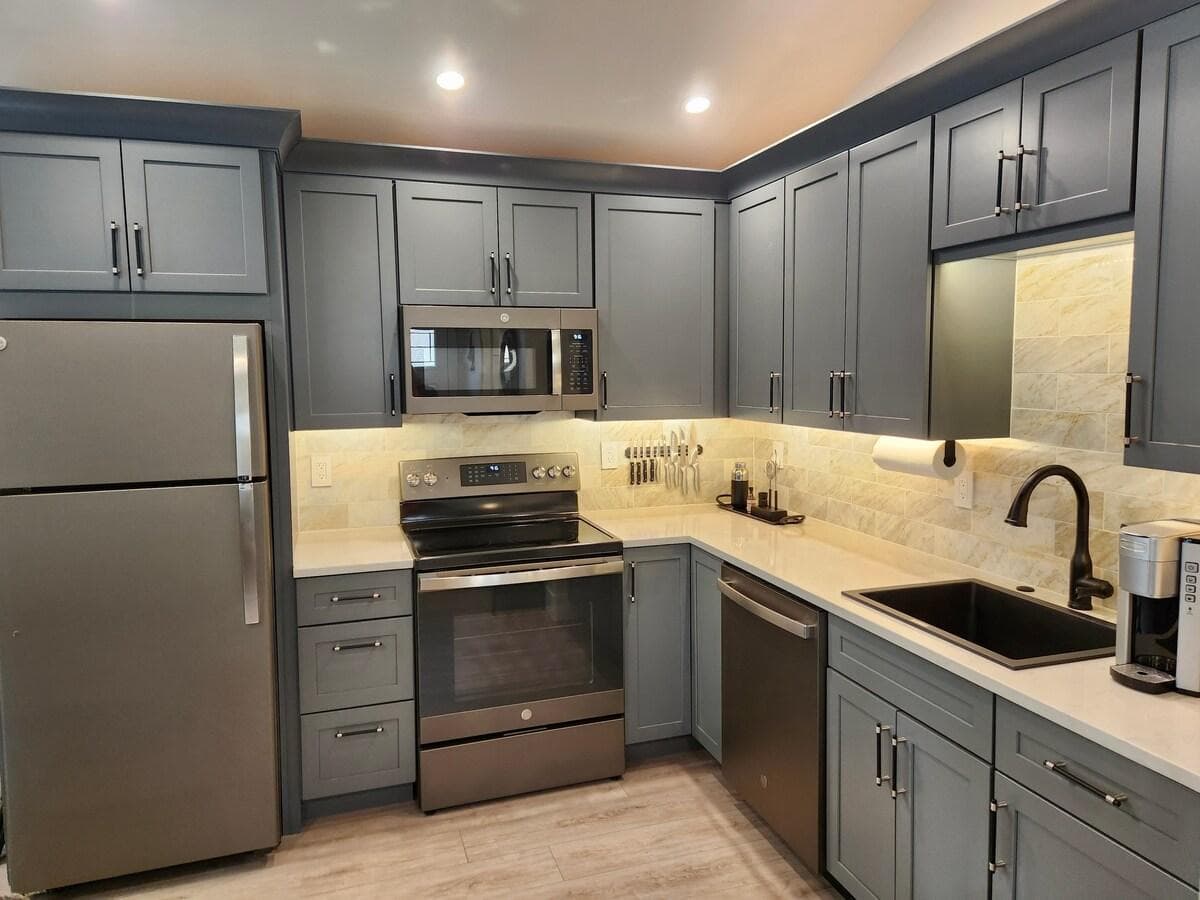 Our small kitchen is stocked with Crate & Barrel china and flatware, serving dishes, frying & sauce pans, baking sheet, a pyrex baking dish, a toaster, pizza sheet, an assortment of utensils, food storage, spices, olive oil, beverage sweetener, etc